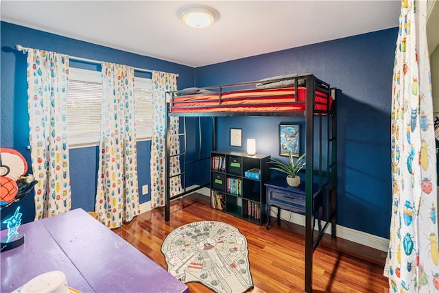 101 Llano Dr, Portland, TX 78374 - bedroom featuring wood finished floors, a textured wall, and baseboards