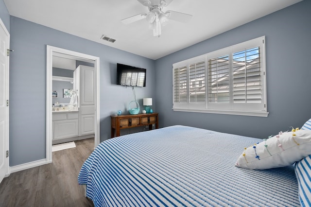 1819 Bay Shore Dr, Rockport, TX 78382 - bedroom with wood finished floors, baseboards, ensuite bathroom, and ceiling fan