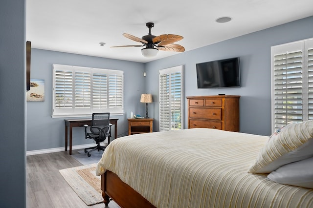 1819 Bay Shore Dr, Rockport, TX 78382 - bedroom with wood finished floors, baseboards, ceiling fan, and a desk
