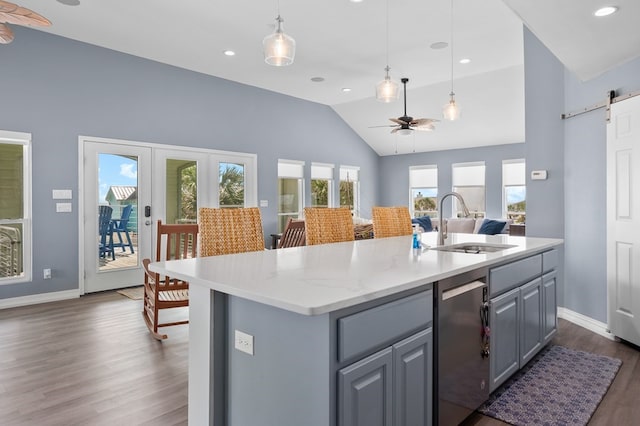 1819 Bay Shore Dr, Rockport, TX 78382 - kitchen with gray cabinets, a barn door, a ceiling fan, dark wood-style floors, and a sink