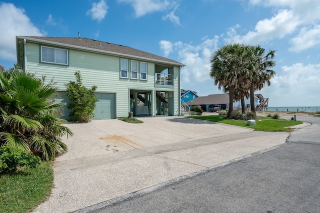 1819 Bay Shore Dr, Rockport, TX 78382 - view of front of house featuring stairway, concrete driveway, and an attached garage