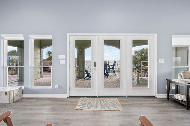 1819 Bay Shore Dr, Rockport, TX 78382 - doorway to outside featuring healthy amount of natural light, baseboards, and wood finished floors
