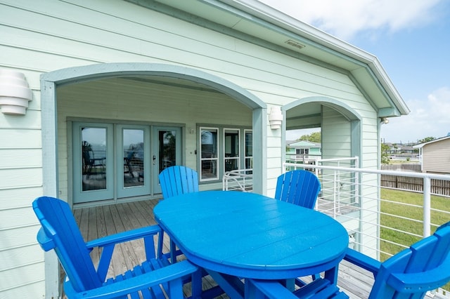 1819 Bay Shore Dr, Rockport, TX 78382 - wooden deck with french doors and outdoor dining area