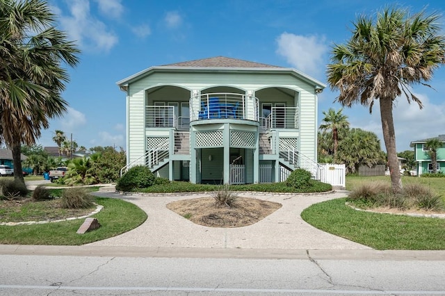 1819 Bay Shore Dr, Rockport, TX 78382 - view of front facade featuring stairway and covered porch