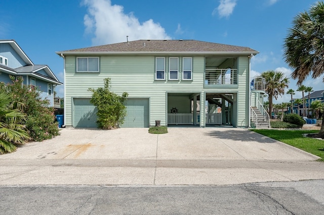 1819 Bay Shore Dr, Rockport, TX 78382 - view of front of property with driveway, an attached garage, and stairway