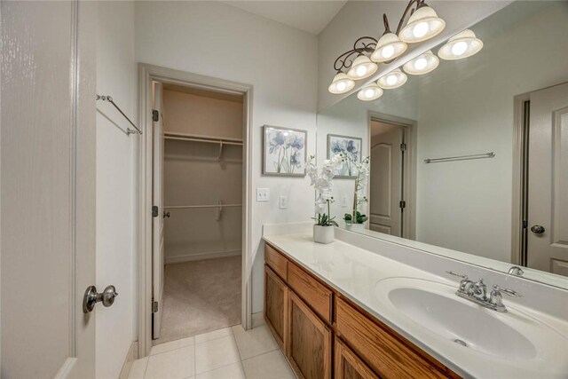 46 E Bar Le Doc Dr, Corpus Christi, TX 78414 - full bath with vanity, tile patterned floors, a walk in closet, and baseboards