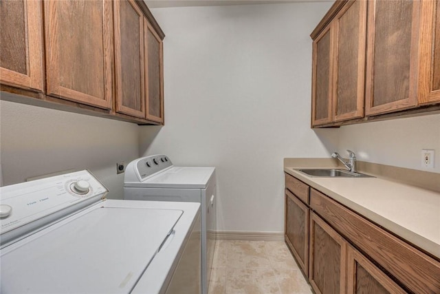 46 E Bar Le Doc Dr, Corpus Christi, TX 78414 - washroom featuring washing machine and dryer, cabinet space, baseboards, and light tile patterned floors