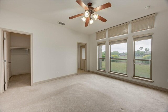 46 E Bar Le Doc Dr, Corpus Christi, TX 78414 - unfurnished bedroom with carpet flooring, baseboards, a spacious closet, and a ceiling fan