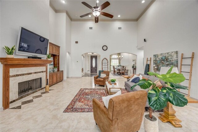 46 E Bar Le Doc Dr, Corpus Christi, TX 78414 - living room featuring arched walkways, a ceiling fan, ornamental molding, a high ceiling, and recessed lighting