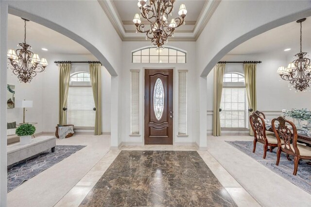 46 E Bar Le Doc Dr, Corpus Christi, TX 78414 - foyer entrance featuring a chandelier, ornamental molding, arched walkways, baseboards, and a towering ceiling