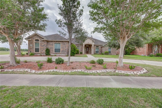 46 E Bar Le Doc Dr, Corpus Christi, TX 78414 - ranch-style home featuring a front lawn and stone siding