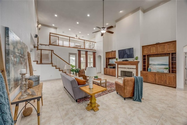 46 E Bar Le Doc Dr, Corpus Christi, TX 78414 - living room featuring a towering ceiling, ornamental molding, stairs, recessed lighting, and a fireplace