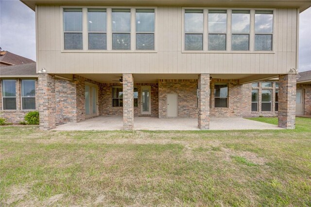 46 E Bar Le Doc Dr, Corpus Christi, TX 78414 - rear view of property featuring a patio area, a yard, and brick siding