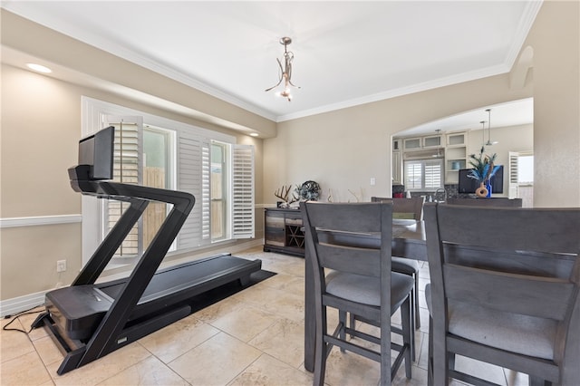 workout area with a notable chandelier and ornamental molding