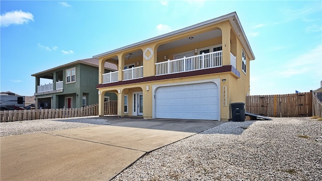 view of front facade with a garage and a balcony