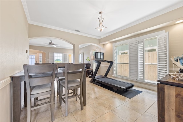 dining space featuring ornamental molding and ceiling fan