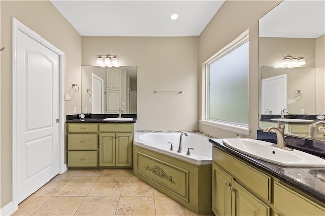 bathroom with a bath, tile patterned flooring, and vanity