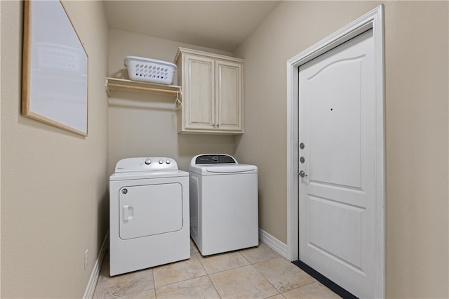 laundry room with cabinets, light tile patterned floors, and independent washer and dryer