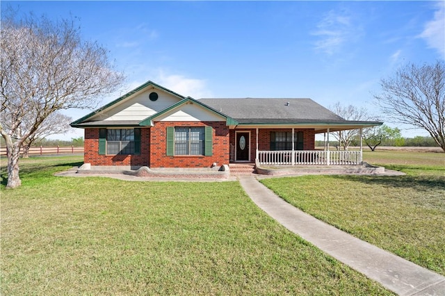 view of front facade featuring brick siding, a porch, and a front yard