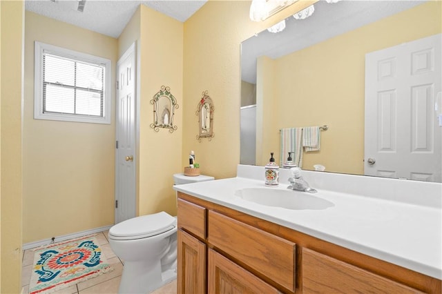 full bathroom featuring vanity, tile patterned floors, and toilet