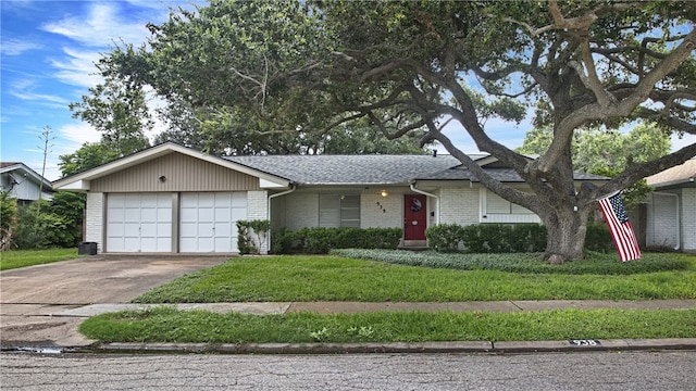 ranch-style home featuring a garage and a front lawn