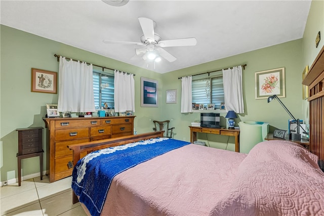 tiled bedroom featuring ceiling fan