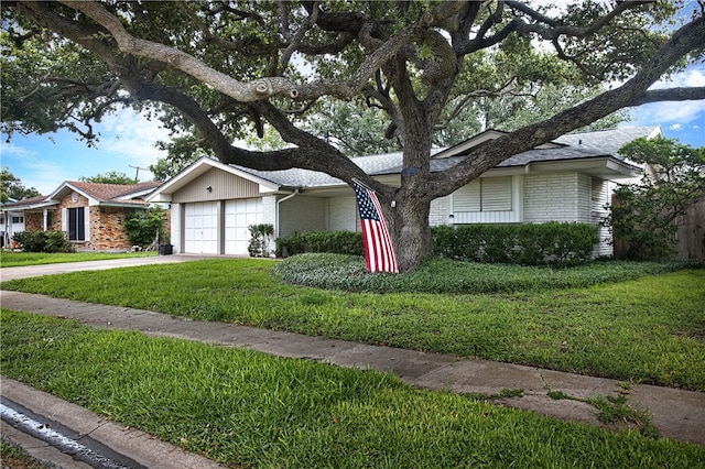 ranch-style house featuring a garage and a front yard