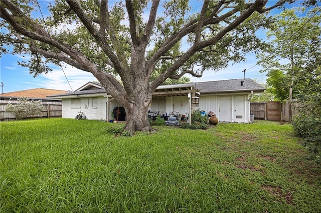 back of house featuring a yard