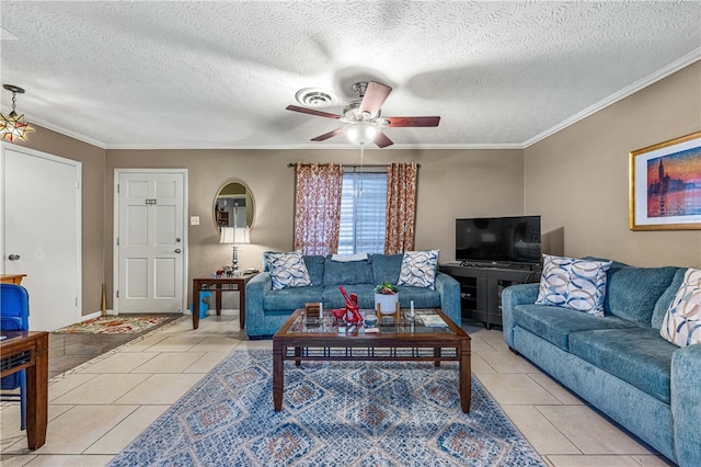 tiled living room with ceiling fan, a textured ceiling, and ornamental molding