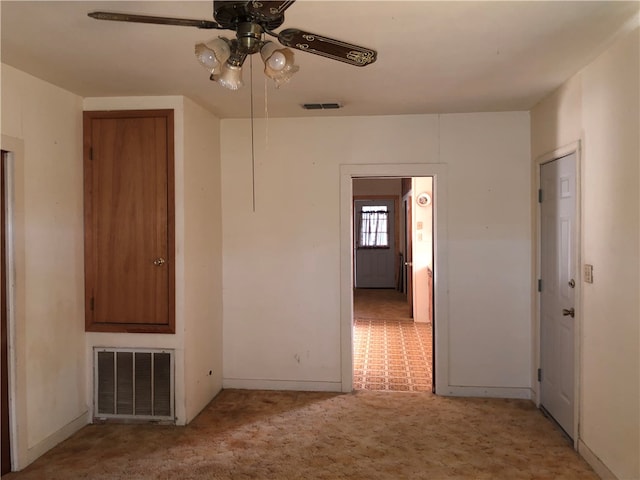 carpeted empty room with ceiling fan