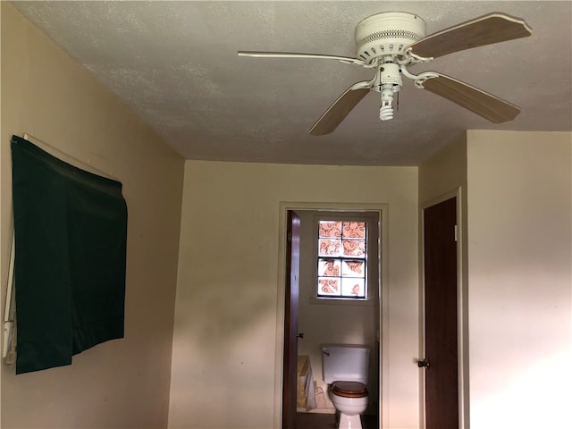 interior space with ensuite bathroom, a textured ceiling, and ceiling fan