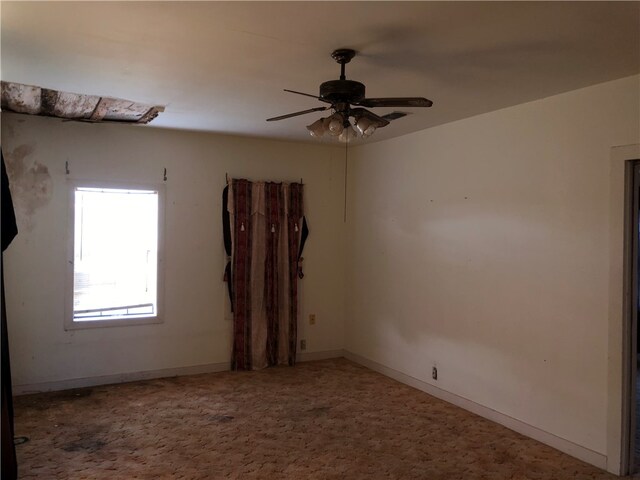 empty room with carpet flooring and ceiling fan