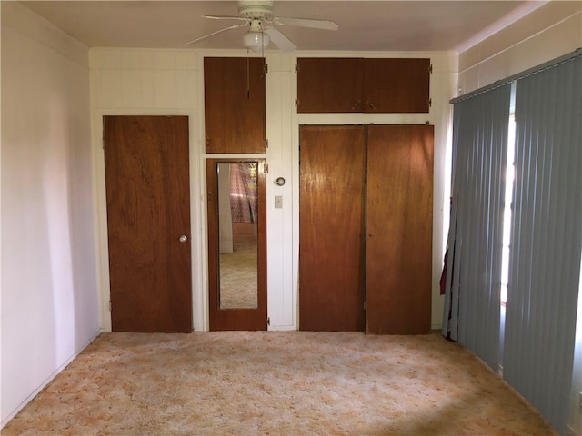 unfurnished bedroom featuring ceiling fan and light carpet