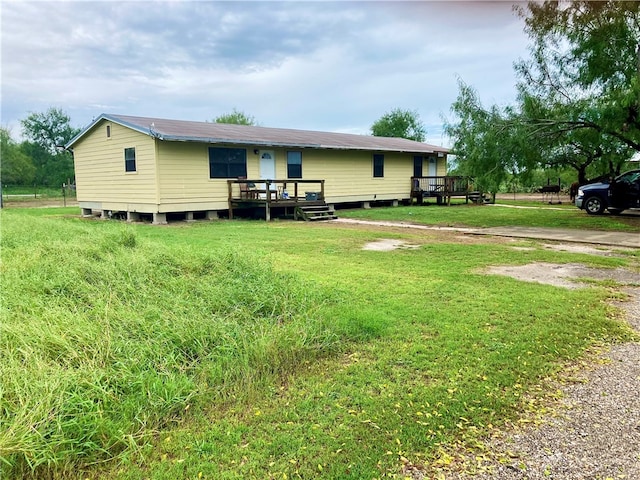 rear view of house with a lawn