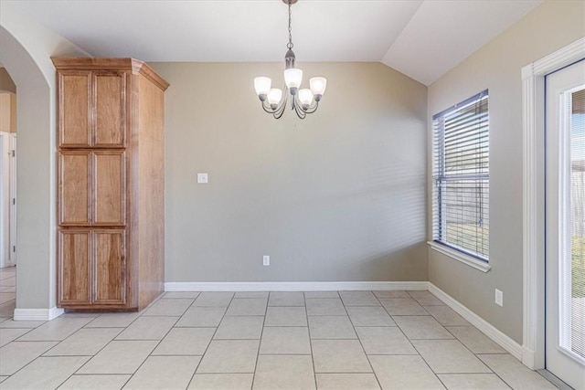 unfurnished dining area featuring lofted ceiling, light tile patterned floors, and a chandelier