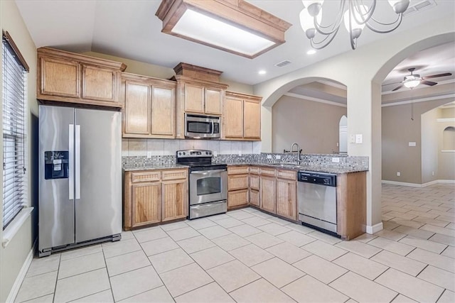 kitchen featuring light tile patterned flooring, sink, backsplash, light stone counters, and stainless steel appliances