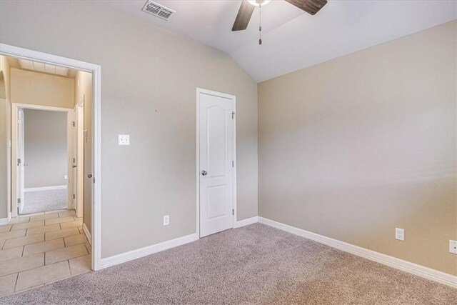 unfurnished bedroom with lofted ceiling, light colored carpet, and ceiling fan