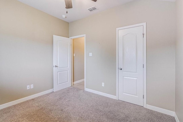 unfurnished bedroom featuring ceiling fan and light colored carpet