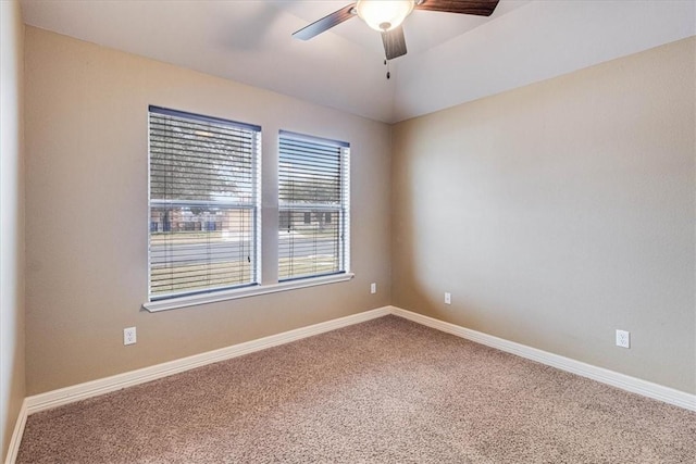 empty room featuring vaulted ceiling, ceiling fan, and carpet flooring