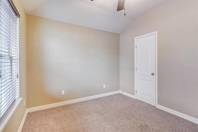 unfurnished room with ceiling fan, lofted ceiling, and carpet