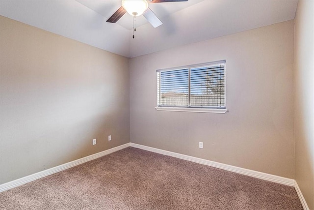 spare room featuring vaulted ceiling, carpet flooring, and ceiling fan