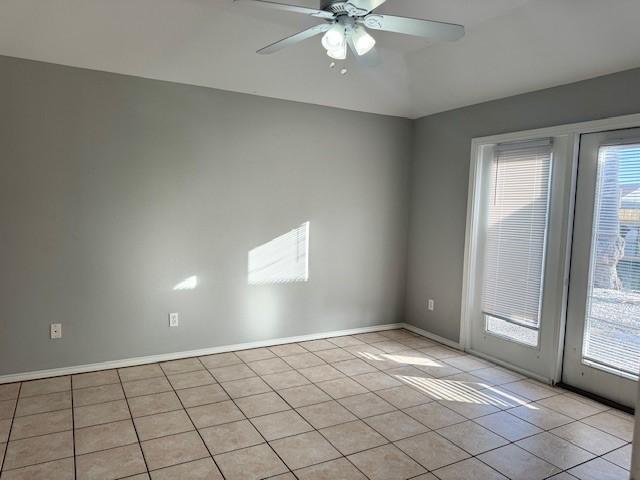 spare room featuring ceiling fan and light tile patterned flooring