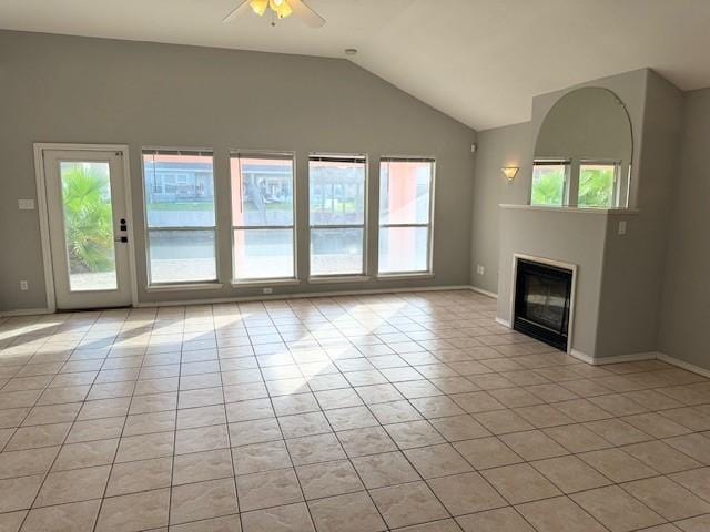 unfurnished living room with ceiling fan, light tile patterned floors, and lofted ceiling