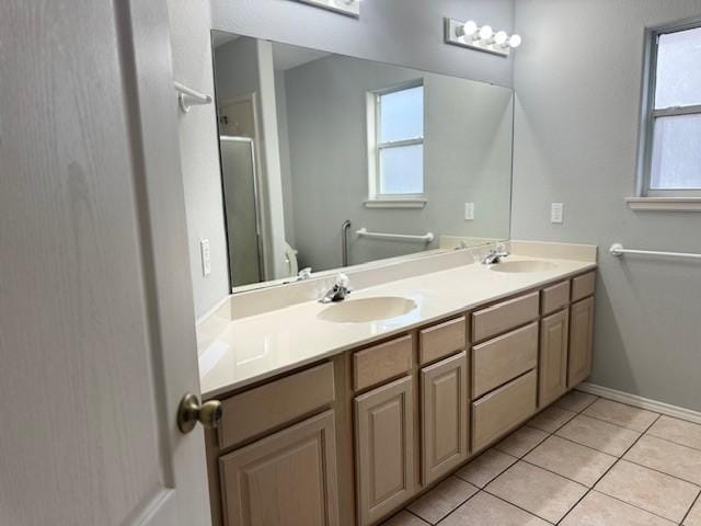 bathroom featuring tile patterned floors, vanity, a healthy amount of sunlight, and toilet