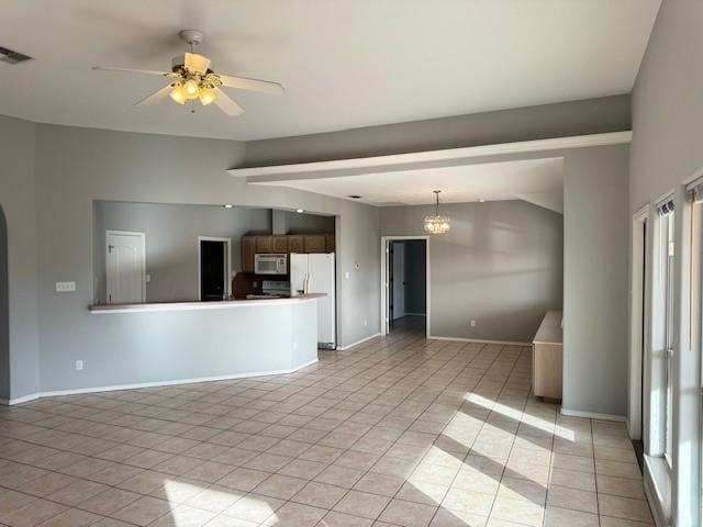 unfurnished living room with ceiling fan with notable chandelier, light tile patterned flooring, and lofted ceiling