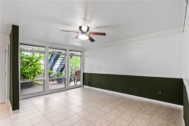 3402 Ocean Dr Unit 16, Corpus Christi, TX 78411 - tiled spare room featuring ceiling fan, a wainscoted wall, and ornamental molding