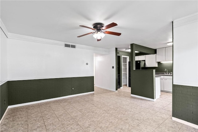 3402 Ocean Dr Unit 16, Corpus Christi, TX 78411 - unfurnished living room featuring ceiling fan, ornamental molding, wainscoting, and light tile patterned floors