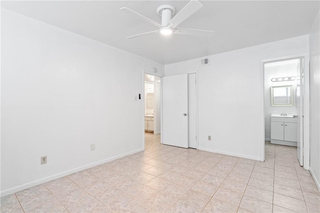 3402 Ocean Dr Unit 16, Corpus Christi, TX 78411 - unfurnished bedroom with ensuite bathroom, light tile patterned floors, and ceiling fan