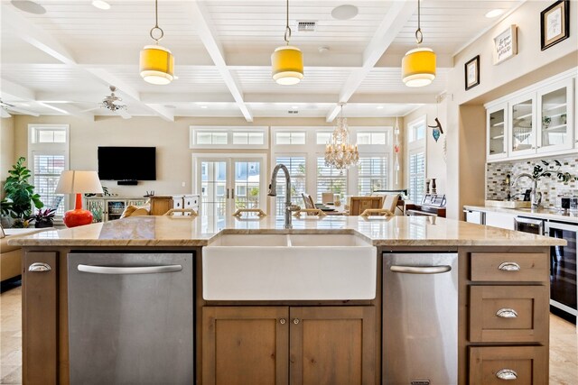 kitchen featuring stainless steel dishwasher, white cabinetry, sink, and decorative light fixtures