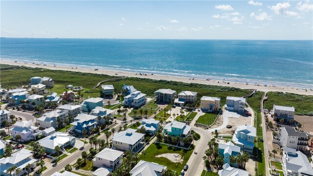 drone / aerial view with a beach view and a water view